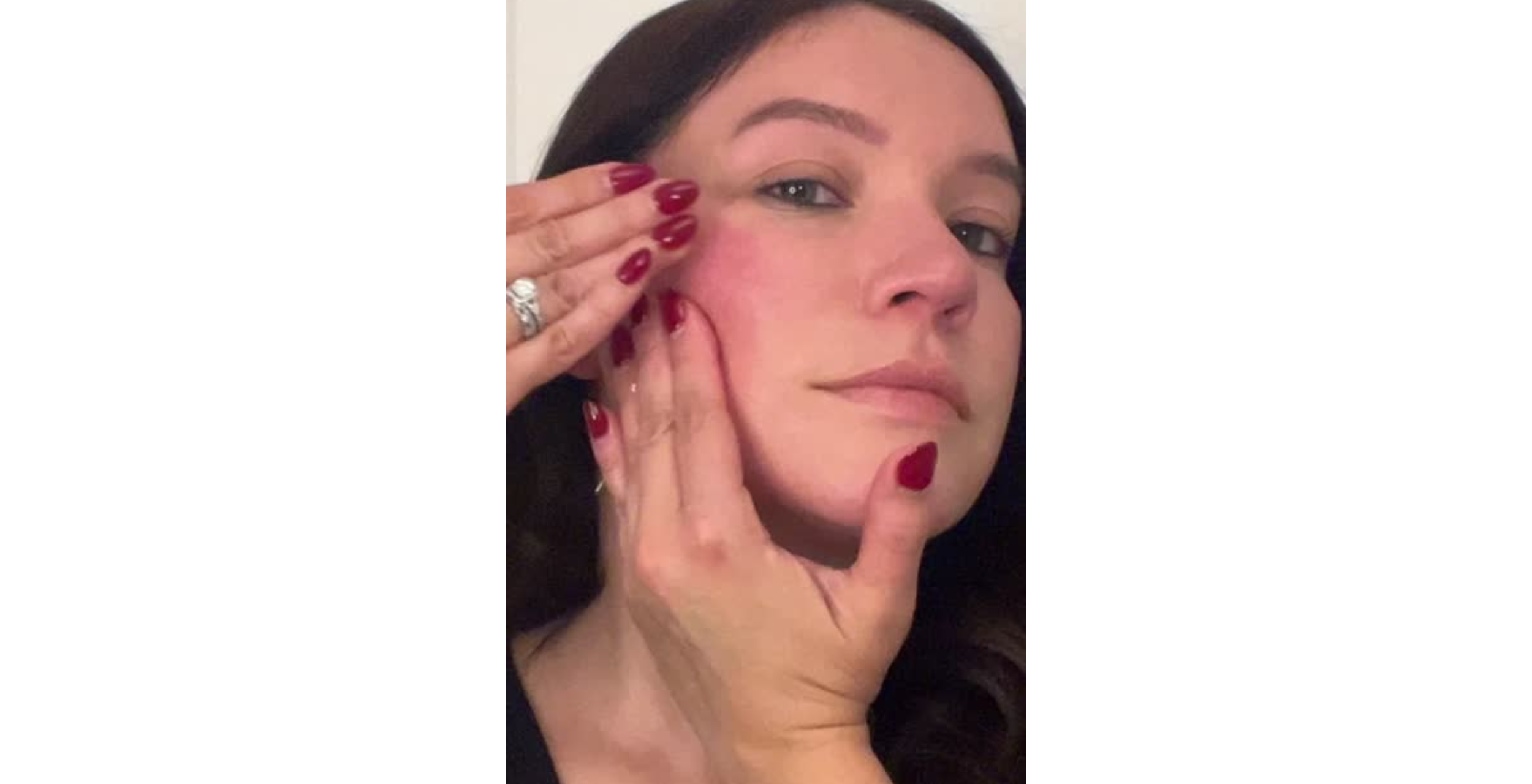 Woman applying makeup with a focus on her face.